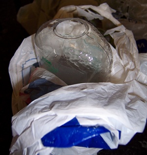 Tesco carrier bag wrapped around a broken shampoo bottle