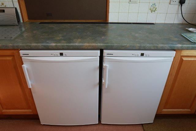 [Under-counter fridge and freezer below the kitchen worktop with a 6cm vent at the back aligned to the space between the cabinets and combined width of the two appliances]