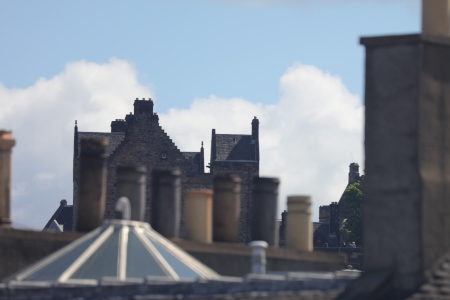 [Western Defences of Edinburgh Castle, visible above and through nearby buildings]