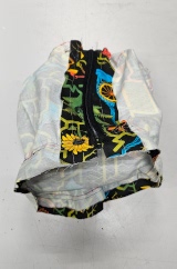 [Patterned fabric doorstop cover, lying empty inside out showing the completed top section and zip along the side]
